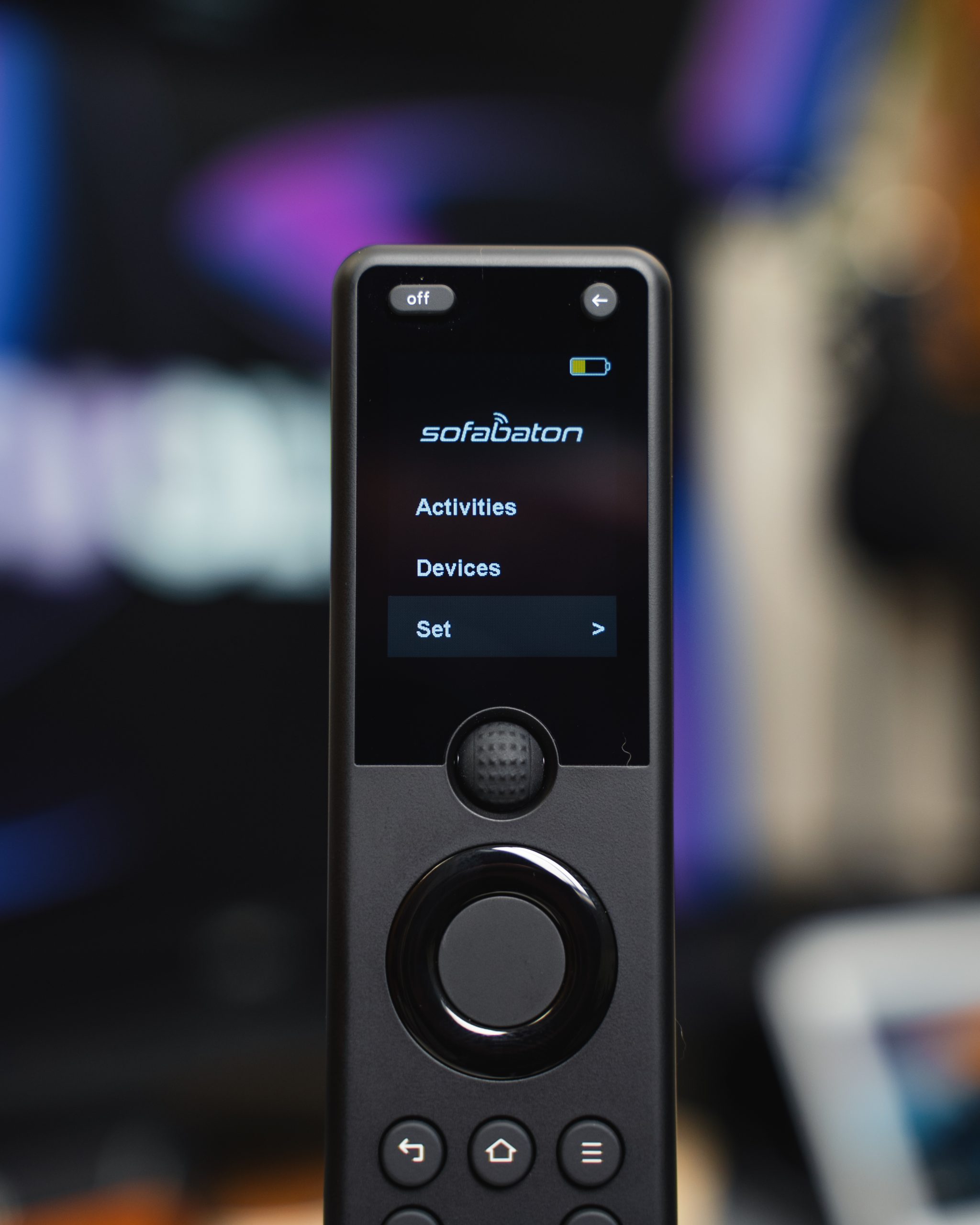 Close-up of a SofaBaton X1S remote showing the Activities and Devices menus.